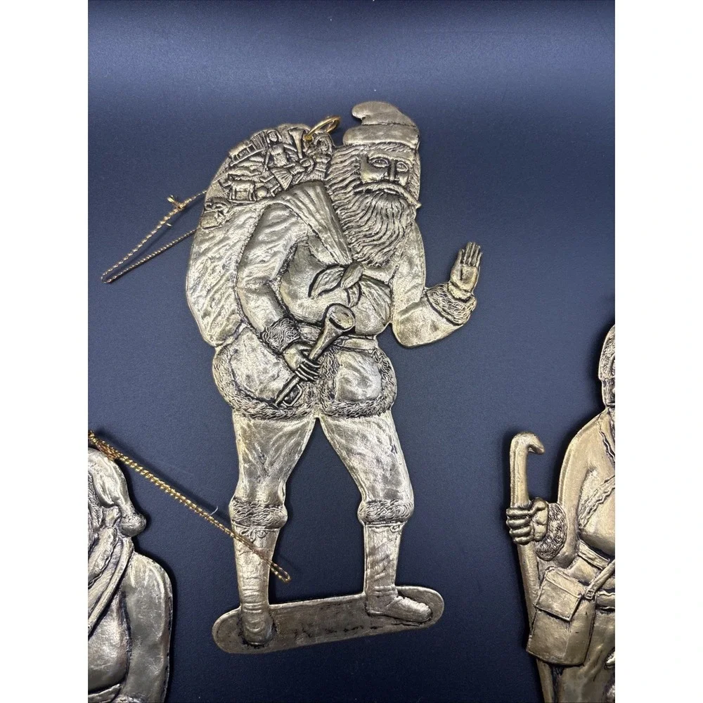4 Vintage pressed‎ metal Santa with Gift Bag Christmas Tree ornaments aprox 6in.